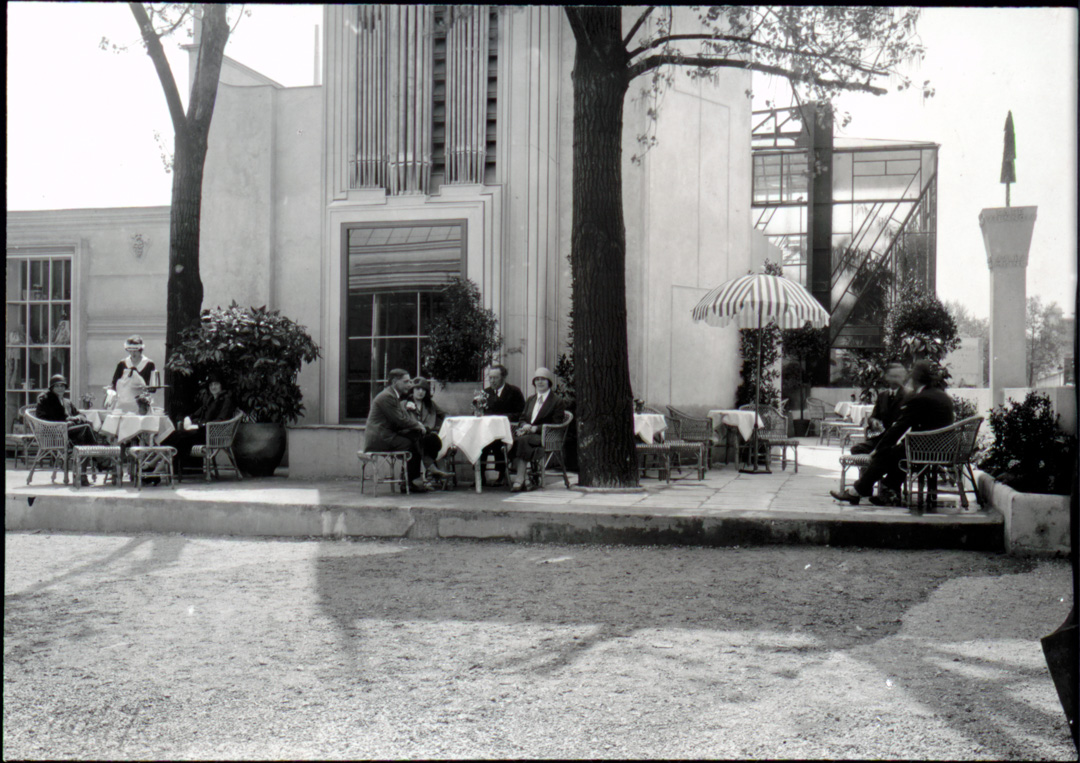 Blick auf die Café-Terrasse mit Orgelturm von Oskar Strnad und Glashaus von Peter Behrens im Hintergrund, Paris 1925; Fotografie. © MAK